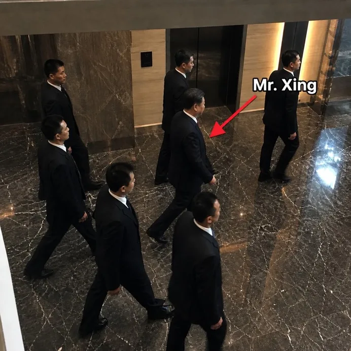 Mr. Xing — a well-dressed Chinese tycoon in a tailored suit